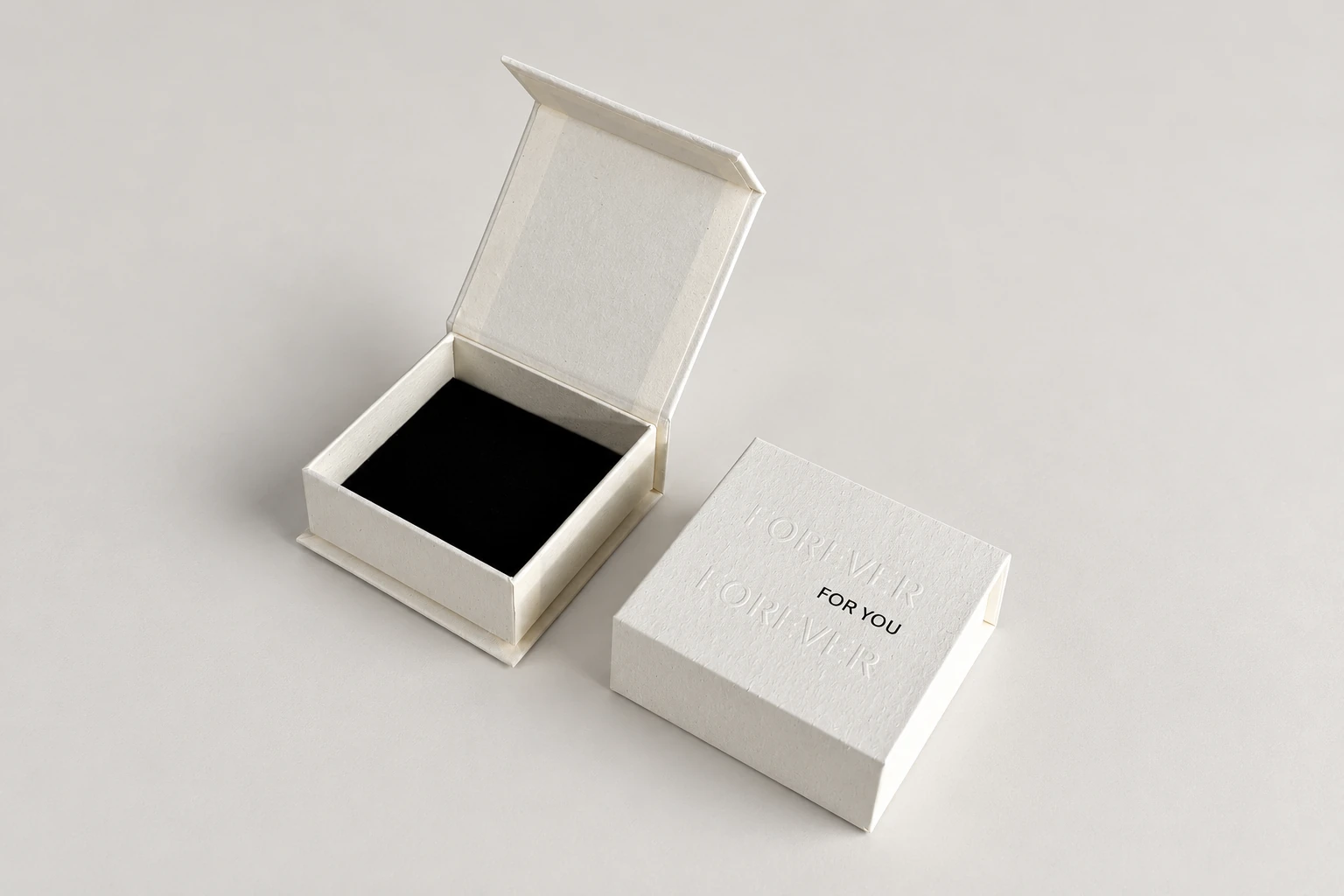 Empty open ivory box with a black base interior next to a matching closed box.